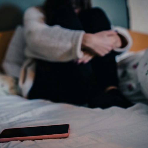 porn-capitalizes-off-of-loneliness-anxiety-depression-mental-health-sad-girl-bed-iphone-teen