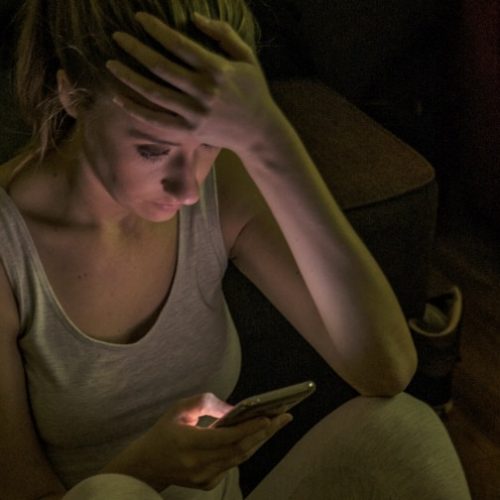 revenge-porn-google-results-victim-woman-phone-sad-girl-dark-nonconsensual