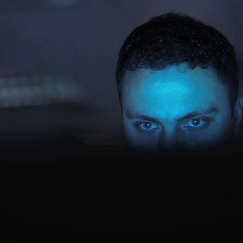 man-trafficker-eyes-dark-computer-glow-use-social-media-groom-control-victims-guy