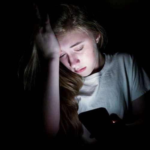 child-self-generated-explicit-content-girl-sad-dark-phone