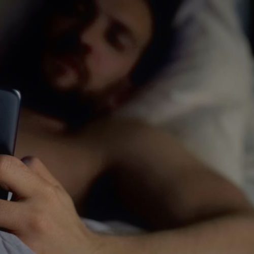 child-predator-pandemic-man-bed-phone-dark